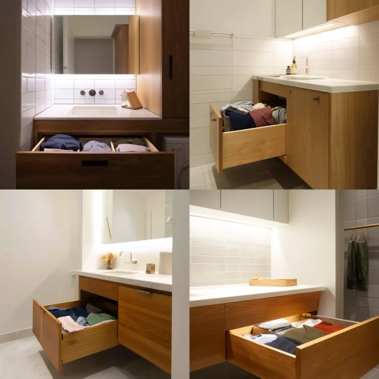 Modern bathroom with built-in hidden laundry hamper drawer in vanity cabinet.